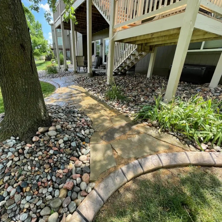 A newly landscaped backyard stone pathway.